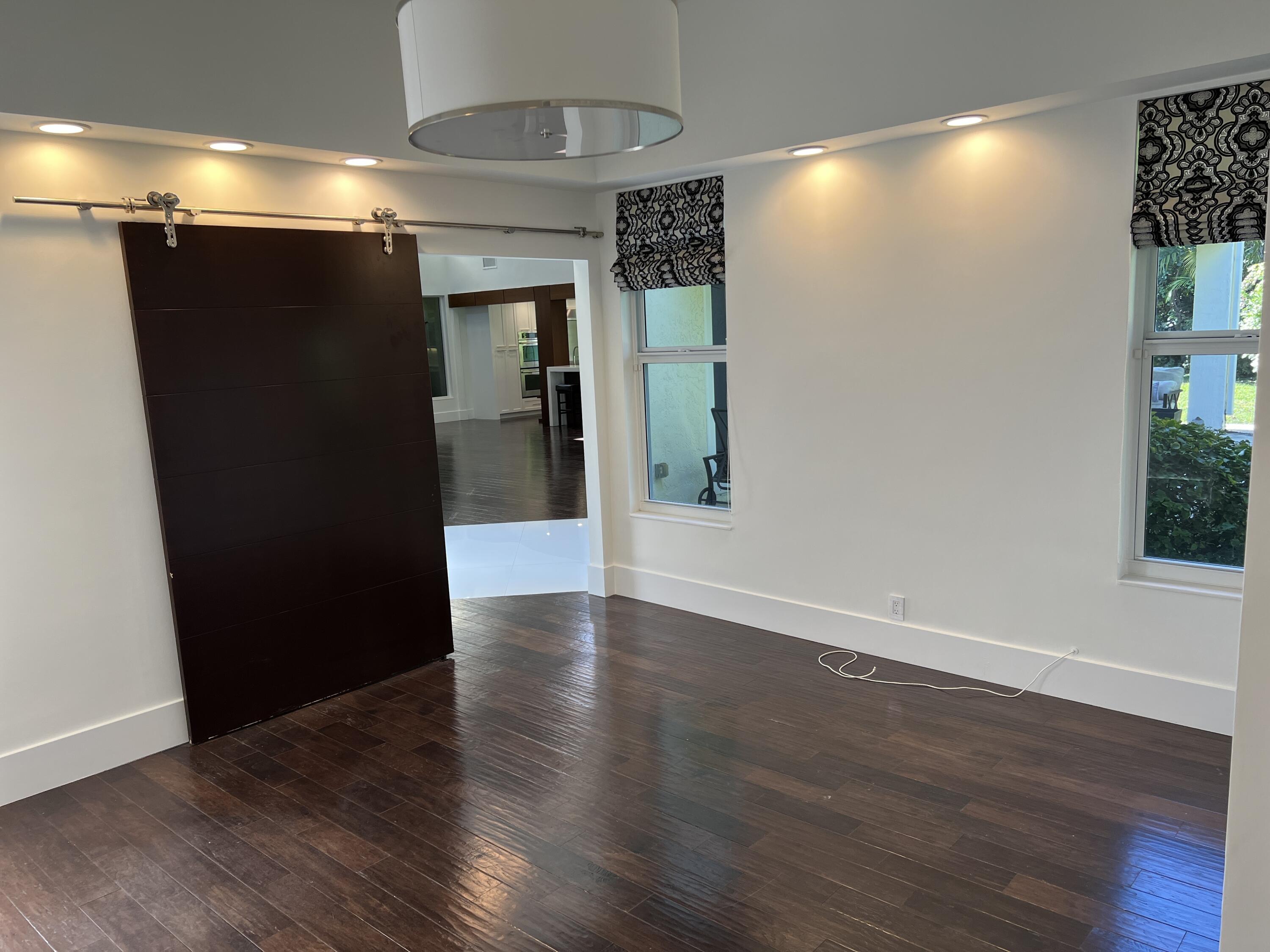 20981 Verano Way Boca Raton, FL 33433 - Photo 16 of 20 a view of a hallway with wooden floor
