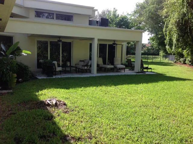 a view of a house with backyard porch and sitting area