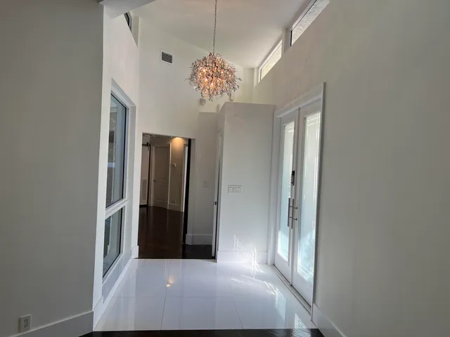 a view of a chandelier fan and entryway