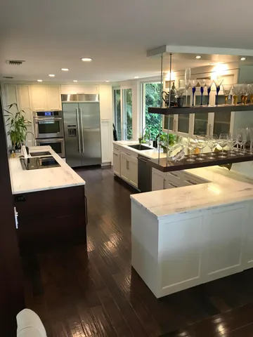 a kitchen with sink and view of living room