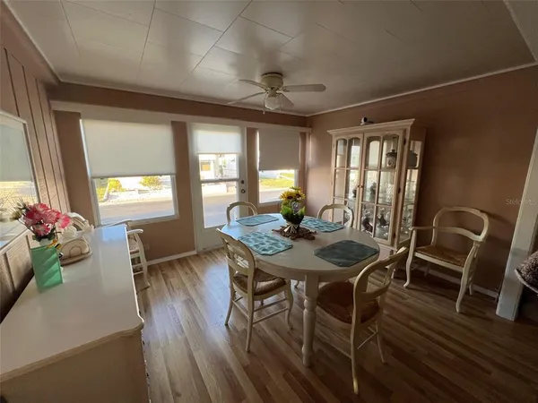 a view of a dining room with furniture window and wooden floor