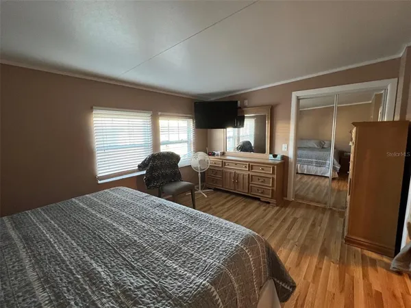 a bedroom with two beds and a window