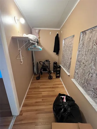 a view of a living room with furniture and storage