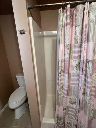 a bathroom with a shower and toilet