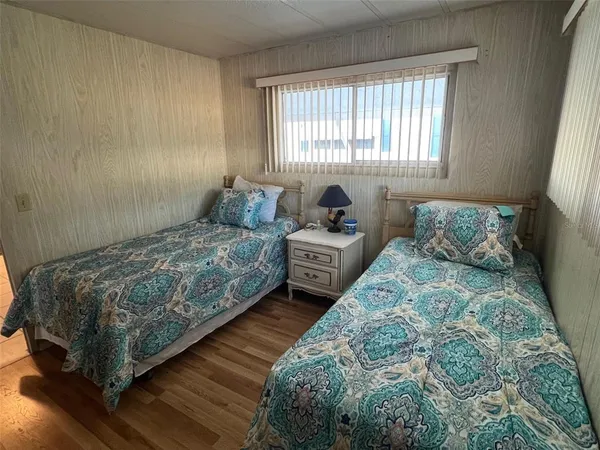 a bedroom with two beds and a window