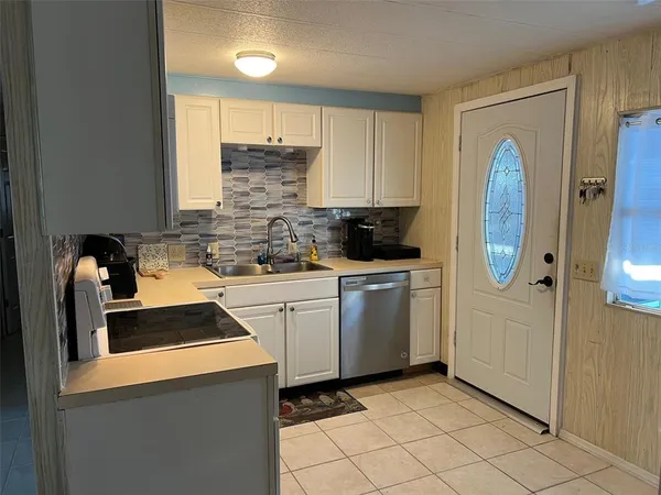 a kitchen that has a sink and a stove in it
