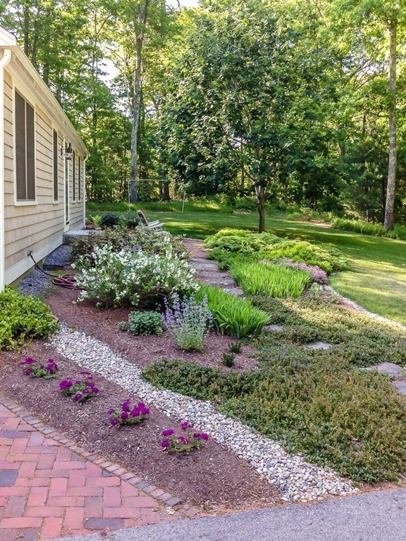 18 Sunrise Road Boxford, MA 01921 - Photo 3 of 22 a view of a garden with plants and large trees
