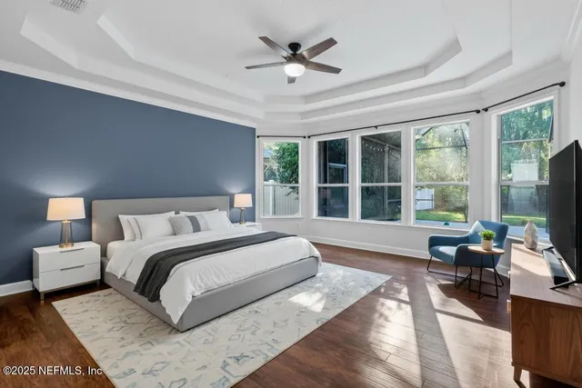 a spacious bedroom with a large bed and a large window