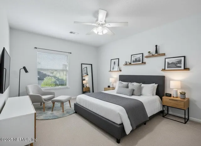 a bedroom with bed and a large window