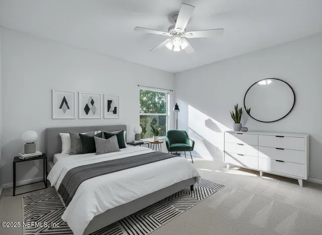 a bedroom with a large bed and a chandelier