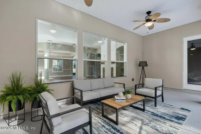 a living room with furniture and a large window