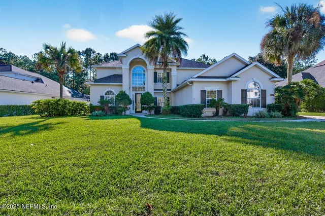 a front view of house with yard and green space