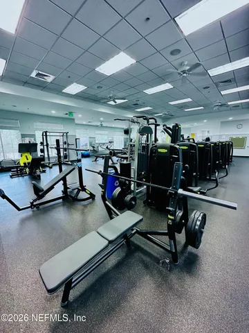 a room with gym equipment and a large window