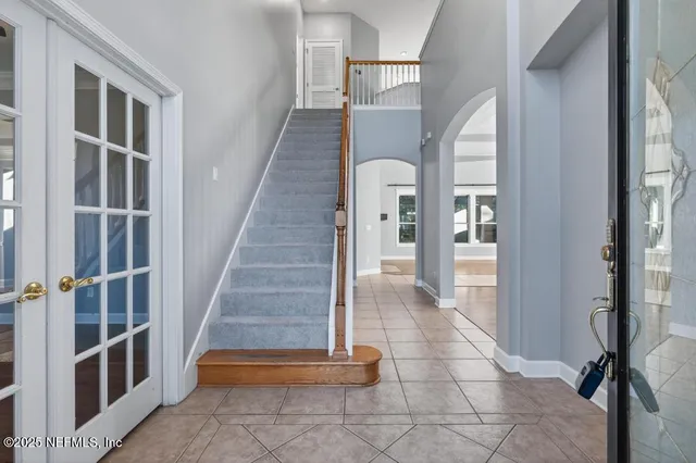 a view of staircase with white walls and windows