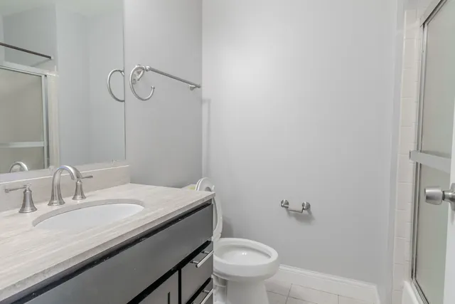 a bathroom with a glass shower door