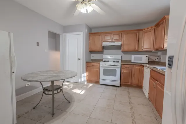 a kitchen with stainless steel appliances a stove a sink dishwasher and a refrigerator