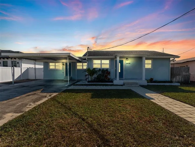 a view of a house with swimming pool next to a yard