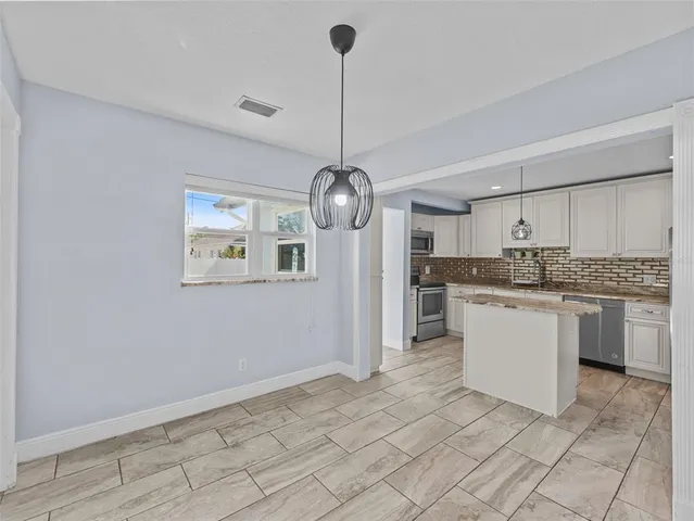a kitchen with a cabinets and chandelier