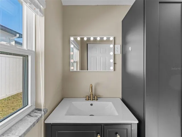 a bathroom with a sink and a mirror