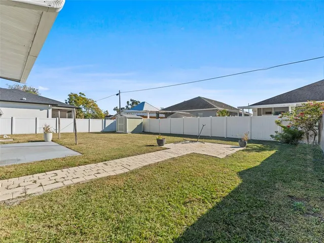 a view of a house with pool and chairs