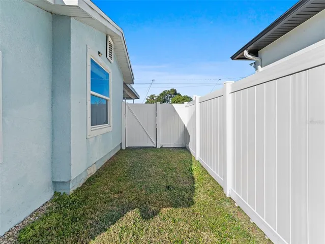 a view of a house with a small yard and plants