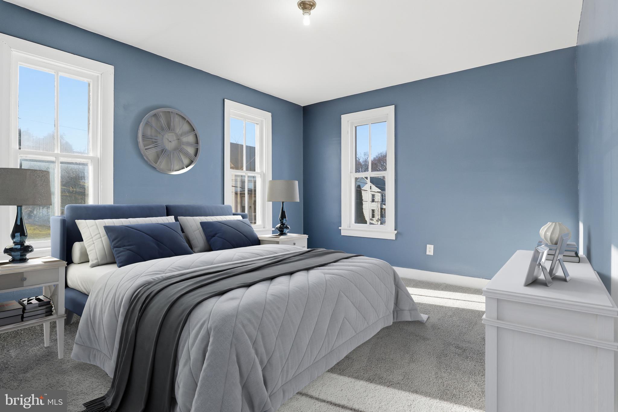 143 West Broad Street Yoe, PA 17313 - Photo 13 of 47 a bedroom with a large bed and a chandelier