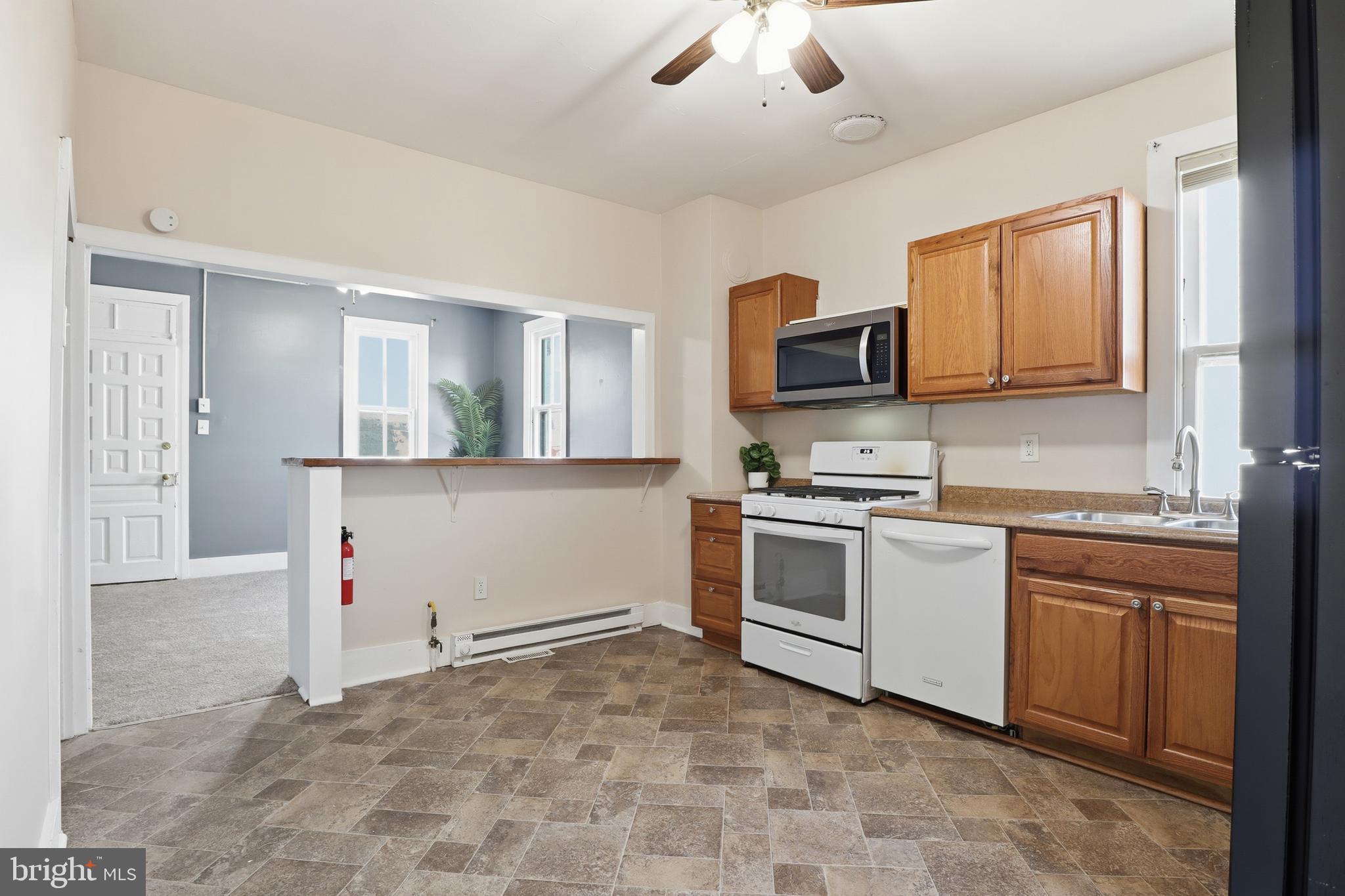143 West Broad Street Yoe, PA 17313 - Photo 8 of 47 a kitchen with granite countertop a stove top oven sink and cabinets
