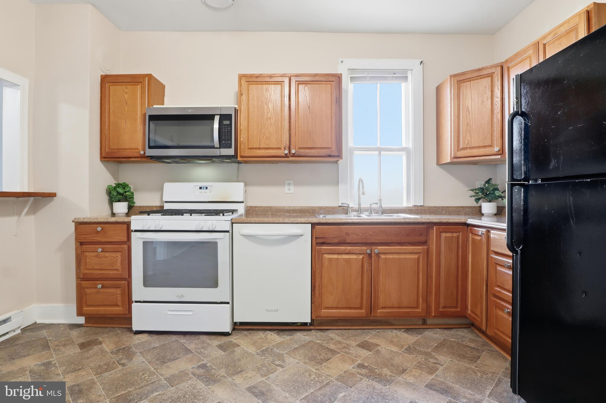 143 West Broad Street Yoe, PA 17313 - Photo 9 of 47 a kitchen with stainless steel appliances granite countertop a refrigerator stove top oven and sink