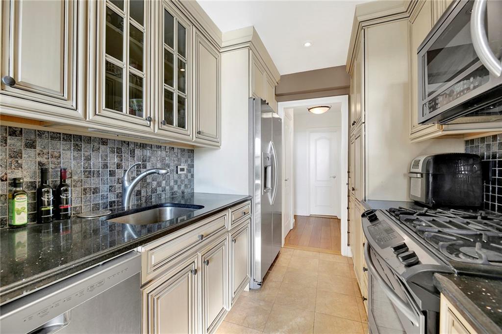 2711 Avenue X, Unit 6C Brooklyn, NY 11235 - Photo 13 of 23 a kitchen with stainless steel appliances granite countertop a sink stove and refrigerator