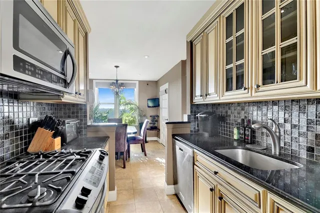 a kitchen with stainless steel appliances granite countertop a stove and a sink