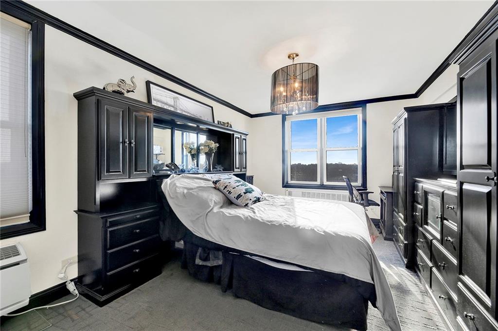 2711 Avenue X, Unit 6C Brooklyn, NY 11235 - Photo 15 of 23 a bed room with a bed a dresser and mirror