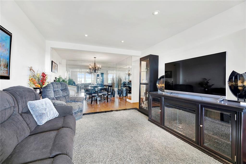 2711 Avenue X, Unit 6C Brooklyn, NY 11235 - Photo 9 of 23 a living room with furniture and a flat screen tv