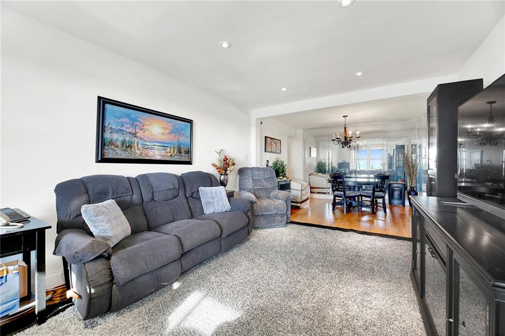 2711 Avenue X, Unit 6C Brooklyn, NY 11235 - Photo 10 of 23 a living room with furniture and a flat screen tv