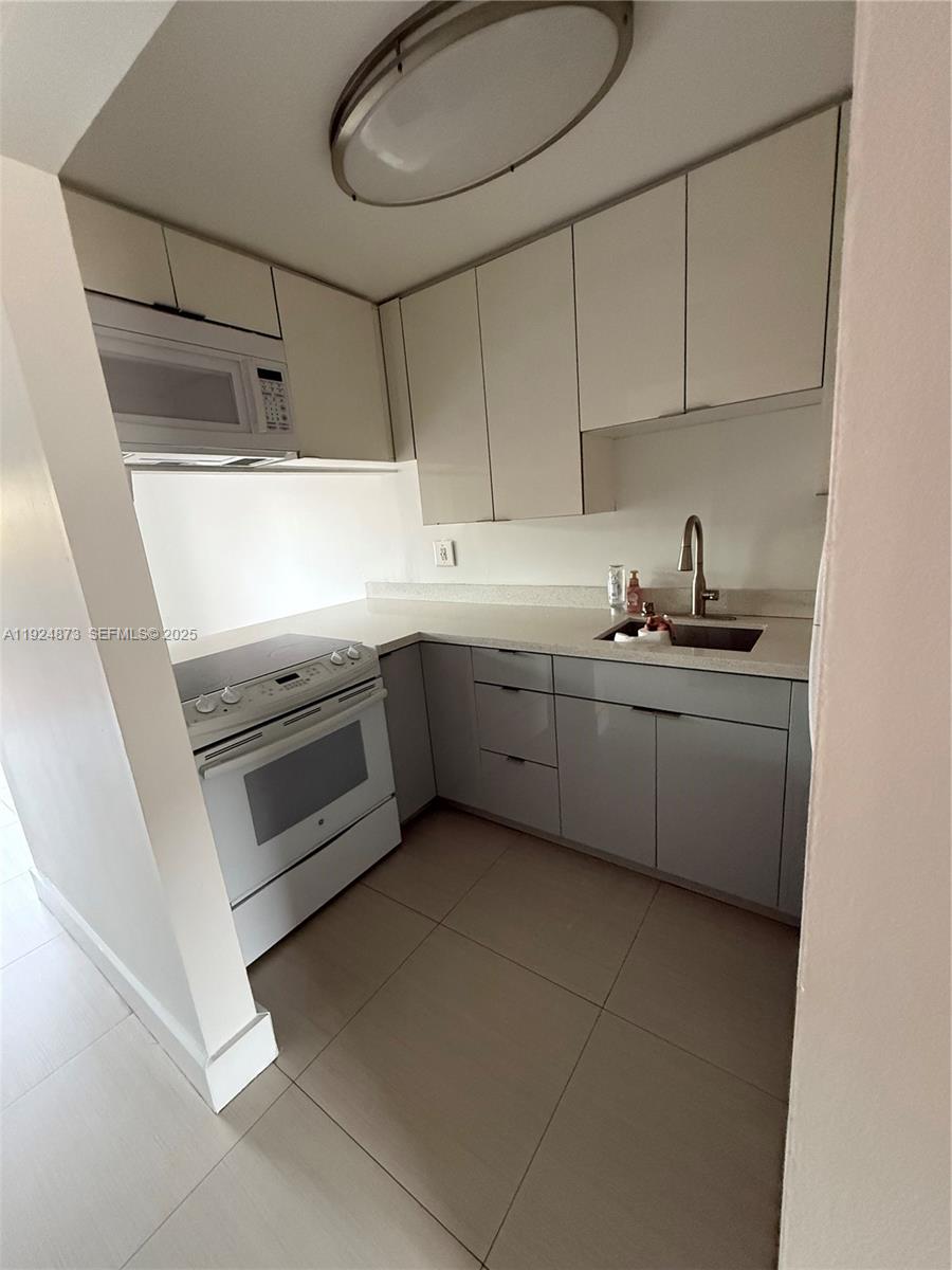 13215 Southwest 57th Terrace, Unit 206 Miami, FL 33183 - Photo 16 of 27 a kitchen with a sink cabinets and appliances