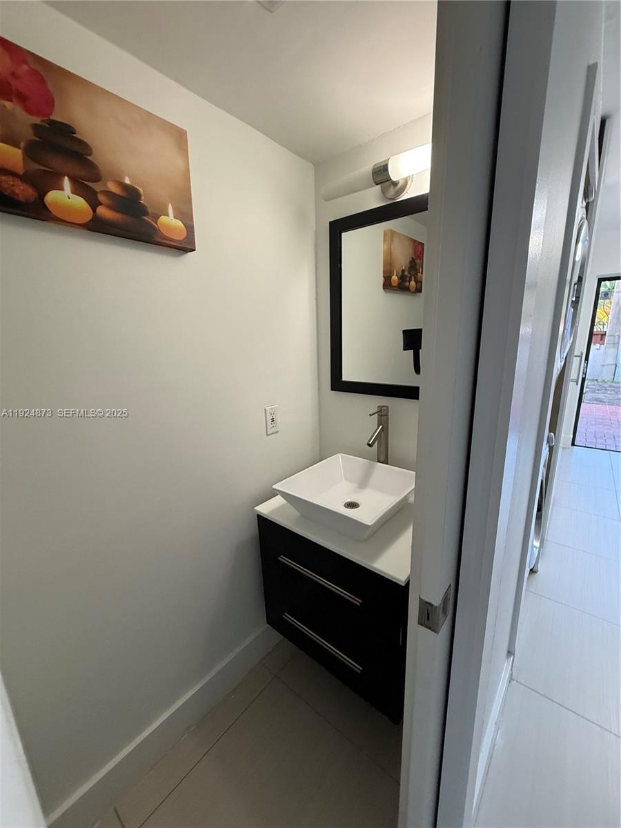13215 Southwest 57th Terrace, Unit 206 Miami, FL 33183 - Photo 22 of 27 a bathroom with a sink and mirror