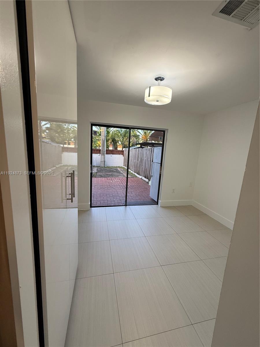 13215 Southwest 57th Terrace, Unit 206 Miami, FL 33183 - Photo 26 of 27 a view of a hallway to rooms and wooden floor