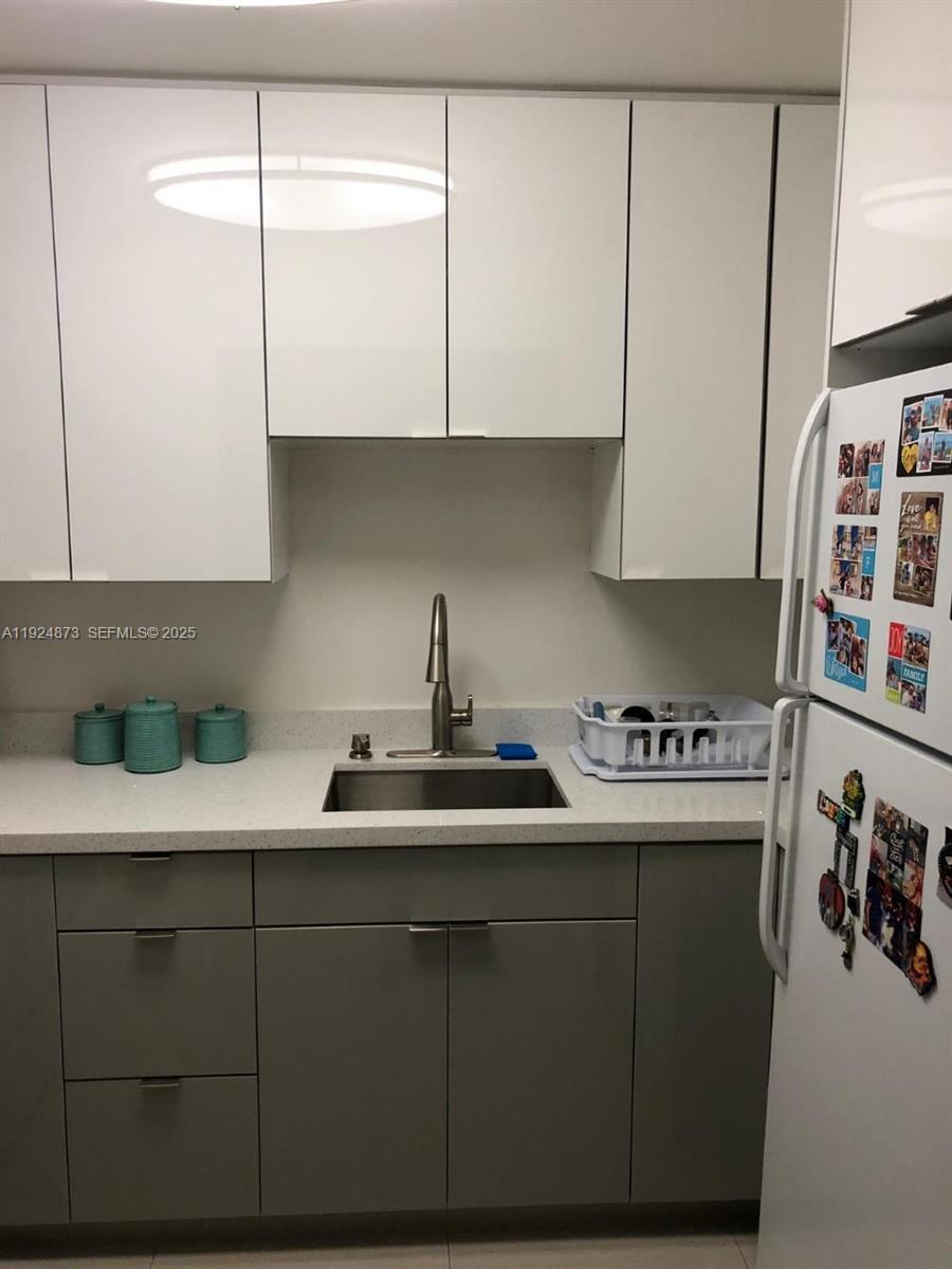 13215 Southwest 57th Terrace, Unit 206 Miami, FL 33183 - Photo 3 of 27 a kitchen with a sink and cabinets
