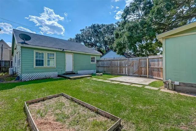 a view of a backyard with a garden and entertaining space