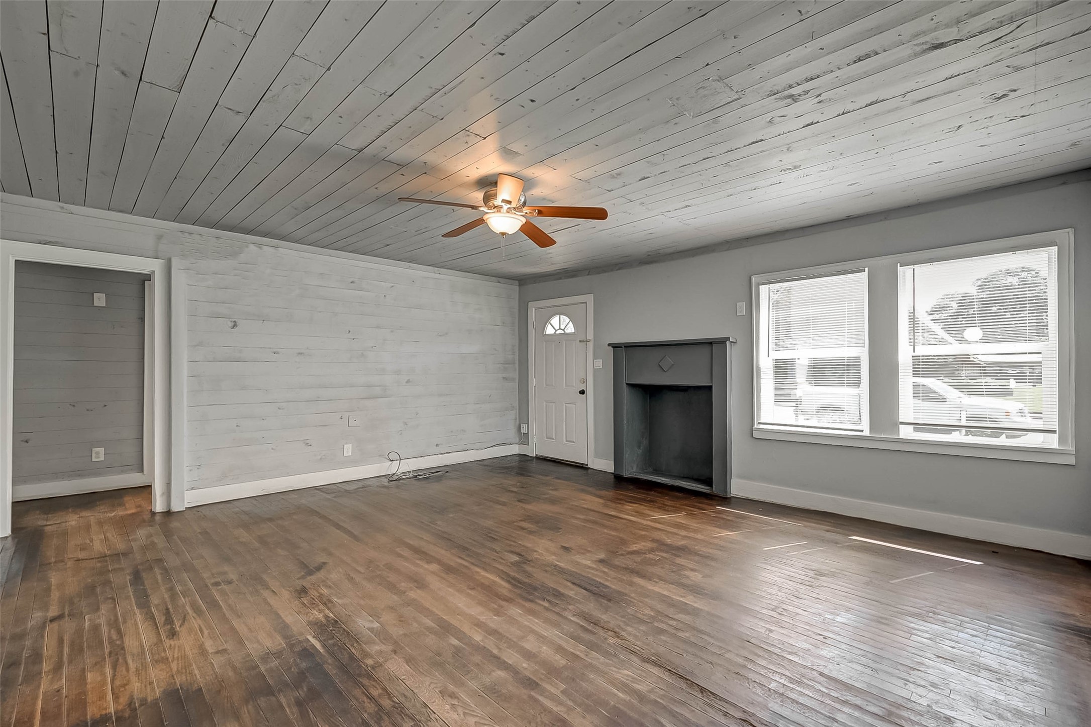 1018 West Sealy Street Alvin, TX 77511 - Photo 3 of 16 a view of an empty room with a window and wooden floor