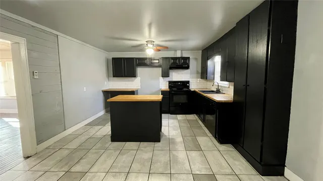 a large kitchen with cabinets and stainless steel appliances