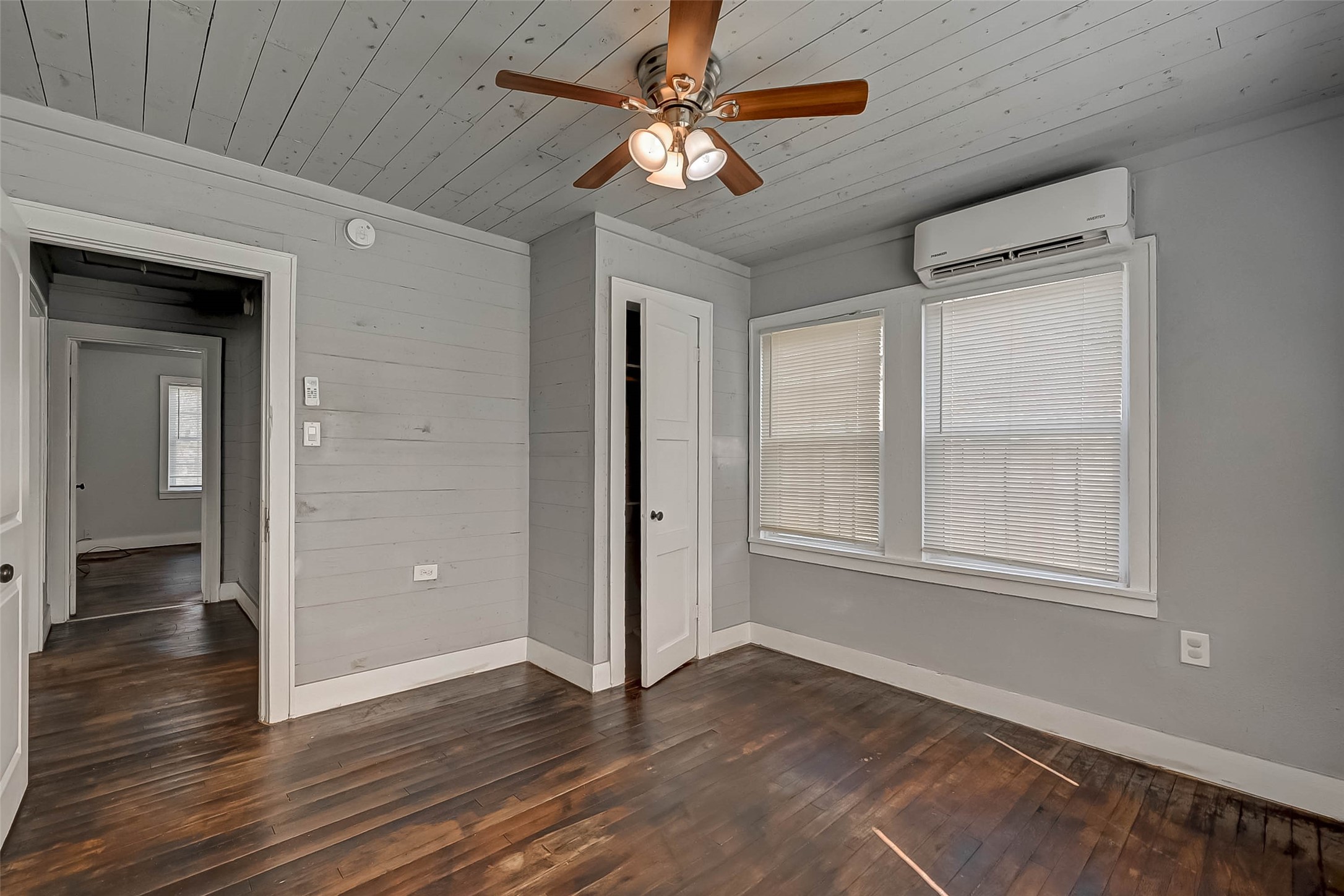 1018 West Sealy Street Alvin, TX 77511 - Photo 9 of 16 a view of an empty room with wooden floor and a window