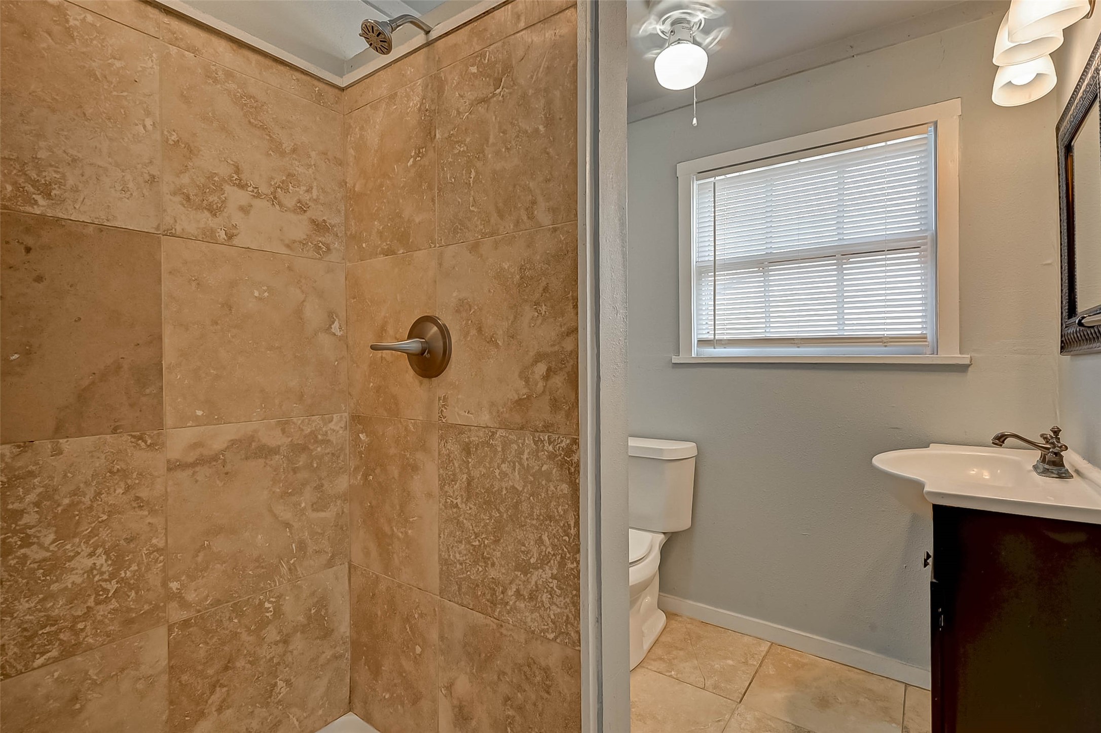 1018 West Sealy Street Alvin, TX 77511 - Photo 10 of 16 a bathroom with a sink and shower