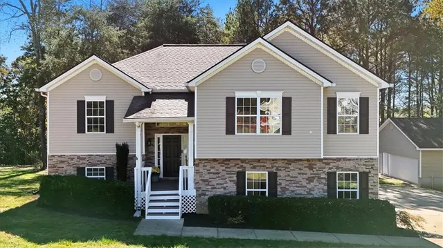 a front view of a house with a yard