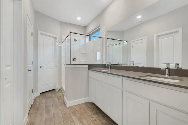 a bathroom with a double vanity sink and mirror