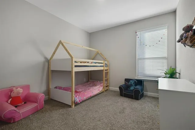 a bedroom with furniture and a potted plant