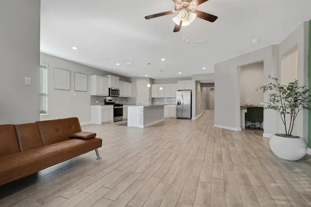 a living room with furniture and kitchen view