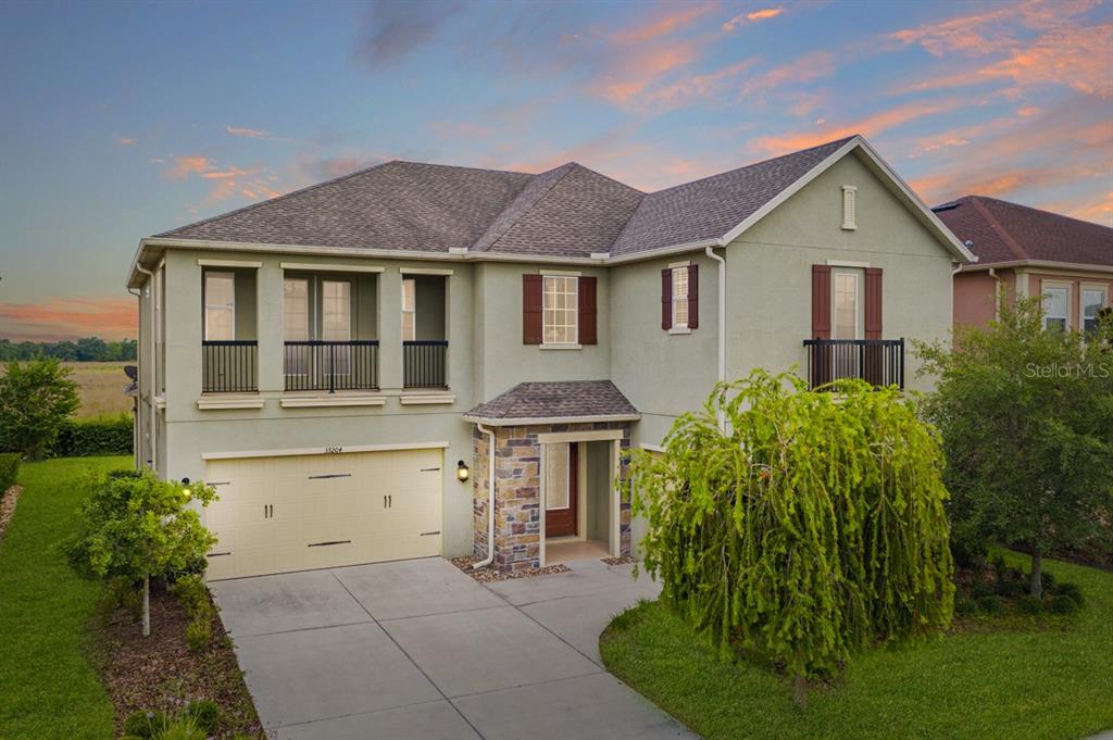 33204 Azalea Ridge Drive Wesley Chapel, FL 33545 - Photo 1 of 1 a front view of a house with garden