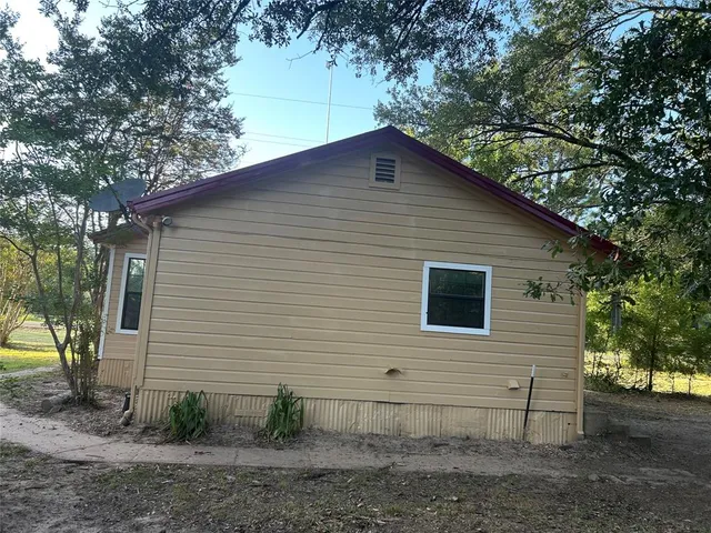 a backyard of a house with lots of trees