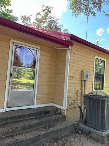 a view of backyard of house with green space