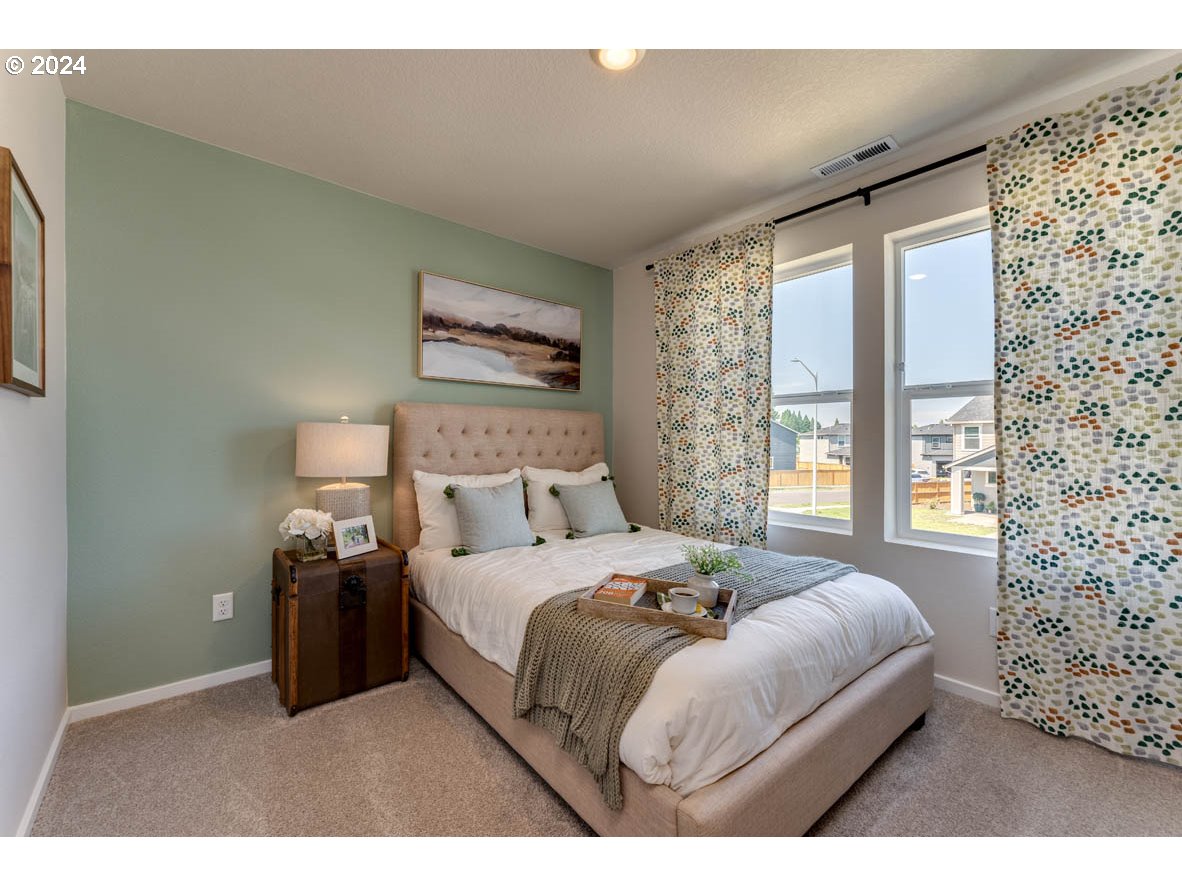 2993 V Street Springfield, OR 97477 - Photo 18 of 24 a bedroom with a bed and a painting on the wall